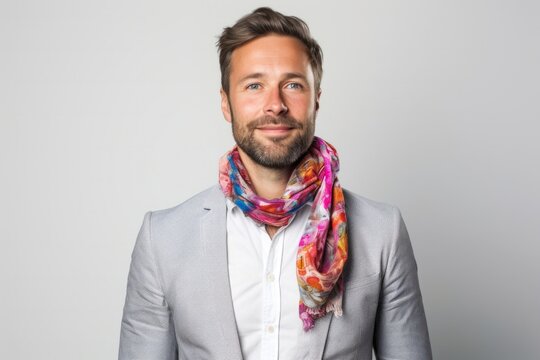 Portrait of a confident Polish man in his 30s wearing a foulard against a white background