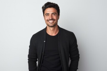 Obraz premium Portrait of a Mexican man in his 30s wearing a chic cardigan against a white background