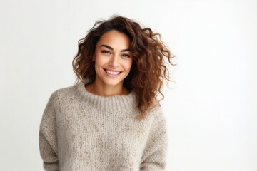 Fototapeta premium medium shot portrait of a happy Israeli woman in her 30s wearing a cozy sweater against a white background