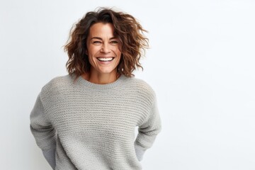 medium shot portrait of a happy Israeli woman in her 40s wearing a cozy sweater against a white background
