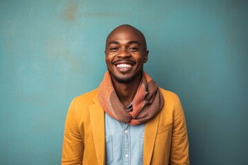 medium shot portrait of a happy Kenyan man in his 30s wearing a chic cardigan against an abstract background