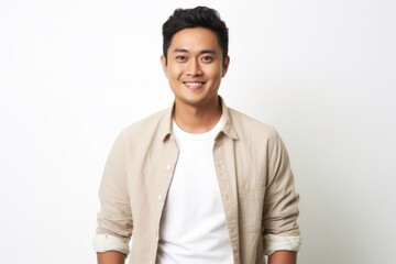 medium shot portrait of a happy Filipino man in his 30s wearing a chic cardigan against a white background
