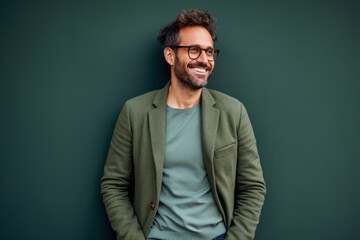 Obraz premium portrait of a happy Polish man in his 30s wearing a chic cardigan against an abstract background