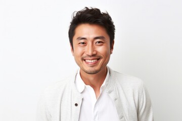 Fototapeta premium medium shot portrait of a happy Japanese man in his 30s wearing a chic cardigan against a white background