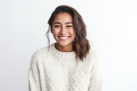 portrait of a happy Filipino woman in her 30s wearing a cozy sweater against a white background
