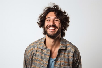 portrait of a happy Israeli man in his 30s wearing a snuggly pajama set against a white background