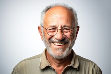 portrait of a happy Israeli man in his 50s wearing a chic cardigan against a white background
