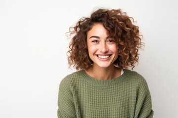 portrait of a happy Israeli woman in her 20s wearing a cozy sweater against a white background