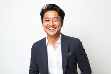 portrait of a happy Japanese man in his 40s wearing a chic cardigan against a white background