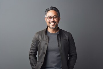Obraz premium medium shot portrait of a Japanese man in his 40s wearing a chic cardigan against a minimalist or empty room background