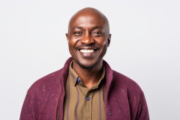 medium shot portrait of a Kenyan man in his 40s wearing a chic cardigan against a white background