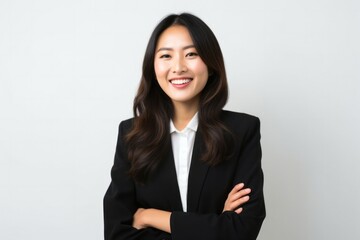 Fototapeta premium portrait of a Filipino woman in her 30s wearing a sleek suit against a white background