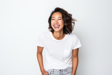 portrait of a Filipino woman in her 30s wearing a fun graphic tee against a white background