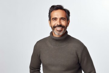 medium shot portrait of a Mexican man in his 40s wearing a cozy sweater against a white background