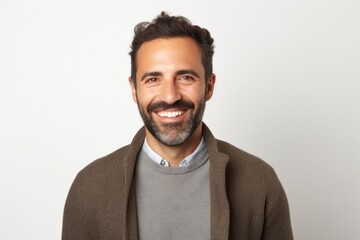 portrait of a Israeli man in his 30s wearing a chic cardigan against a white background