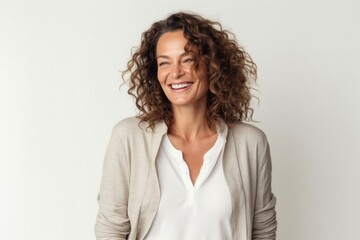 Obraz premium portrait of a Israeli woman in her 40s wearing a chic cardigan against a white background