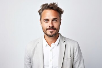 medium shot portrait of a Polish man in his 30s wearing a chic cardigan against a white background