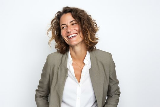 portrait of a Israeli woman in her 40s wearing a chic cardigan against a white background