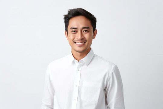 medium shot portrait of a confident Filipino man in his 30s wearing a chic cardigan against a white background