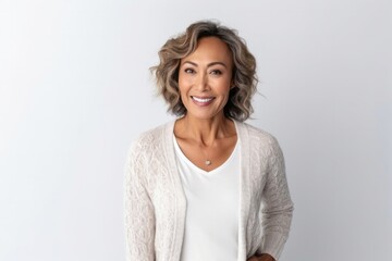 Obraz premium medium shot portrait of a confident Filipino woman in her 40s wearing a chic cardigan against a white background