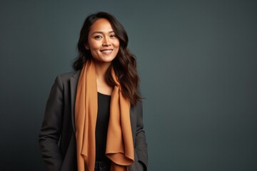 Naklejka premium medium shot portrait of a confident Filipino woman in her 40s wearing a pair of leggings or tights against an abstract background