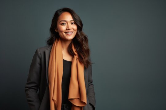 medium shot portrait of a confident Filipino woman in her 40s wearing a pair of leggings or tights against an abstract background