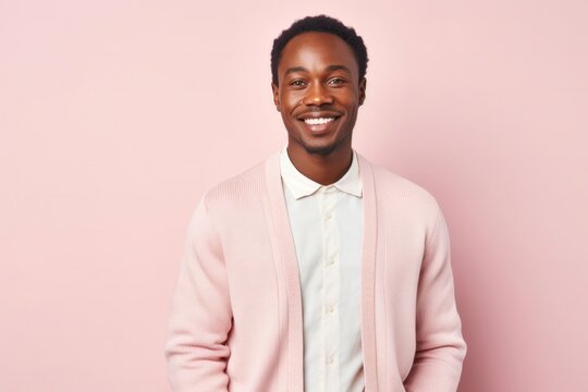 portrait of a Kenyan man in his 30s wearing a chic cardigan against a pastel or soft colors background