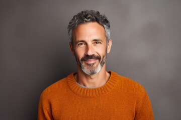 Obraz premium medium shot portrait of a confident Israeli man in his 40s wearing a cozy sweater against an abstract background