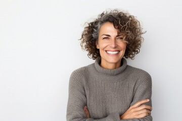 medium shot portrait of a confident Israeli woman in her 40s wearing a cozy sweater against a white background