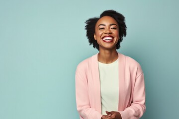 portrait of a Kenyan woman in her 30s wearing a chic cardigan against a pastel or soft colors background - obrazy, fototapety, plakaty