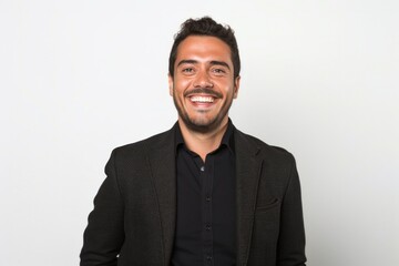 Fototapeta premium portrait of a Mexican man in his 30s wearing a chic cardigan against a white background