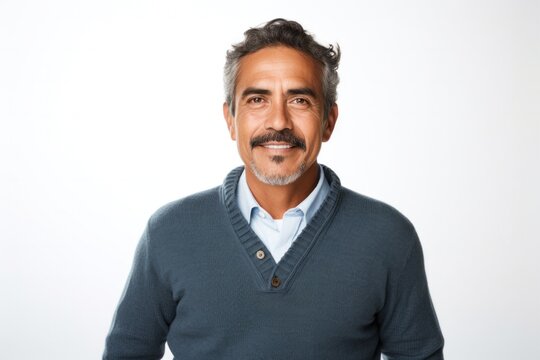 portrait of a Mexican man in his 50s wearing a chic cardigan against a white background