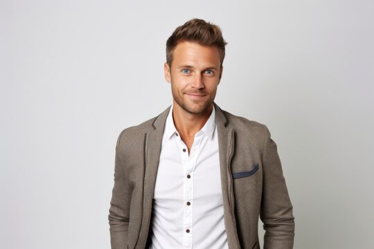 portrait of a Polish man in his 30s wearing a chic cardigan against a white background