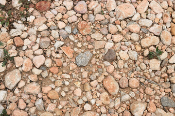 Flat lay of a rural soil full of stones and gravel of different types