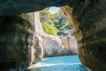 Es Pont de n'Ali, an incredible tunnel in the cliffs. A natural arch that has been eroded into the...