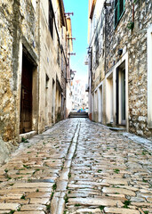 Fototapeta na wymiar Old historic town made of stone. Small village in Croatian coastline. Vodice Street.