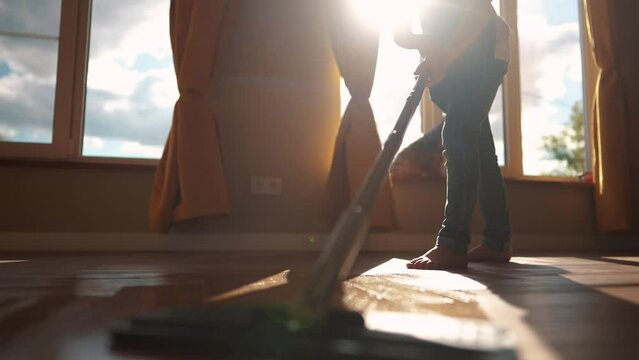 the child baby washed the floors. happy family kid dream concept. daughter washed the floors with a mop in the kitchen indoors in an apron helps mom. mom asked the child girl to mop the floors