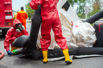 Rescuers wearing red hazmat suits assembled a Inflatable sterilization tunnel tentst. To be used in...