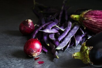 Fresh and healthy vegetables, red onions, long purple beans and eggplants - 649756805