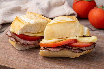 Bauru, traditional brazilian sandwich with roast beef, cheese and tomatoes cut in halves
