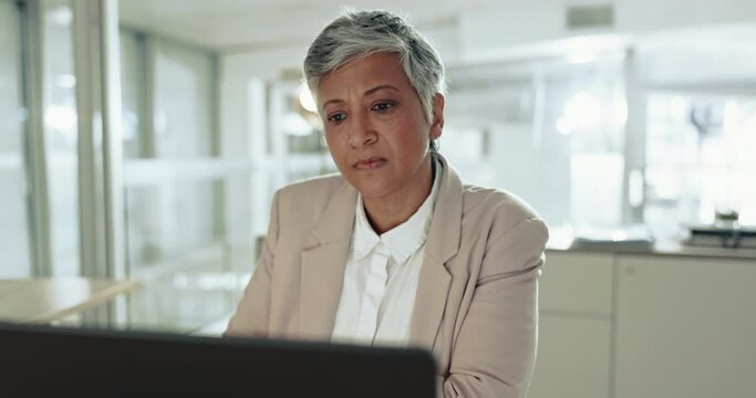 Mature, thinking and business woman on laptop in office, planning and problem solving. Computer, doubt and serious ceo reading email, decision making and brainstorming solution, question and idea