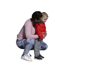 Jeune mère accroupie vue de profil avec son petit garçon en extérieur, vêtus de tenues décontractées de mi-saison, moment de tendresse entre parent et enfant