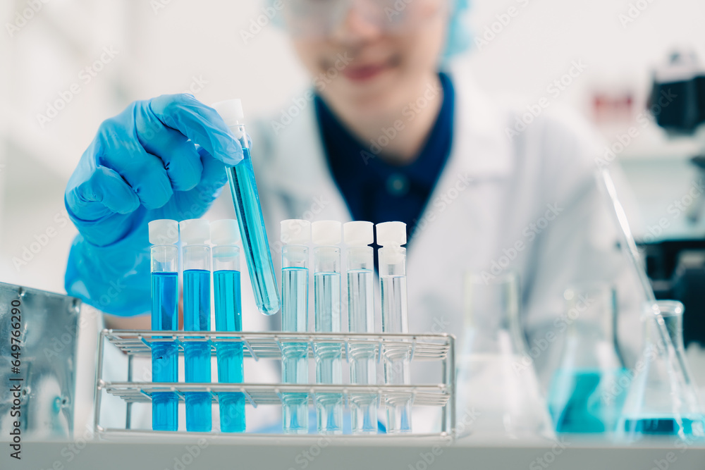 Wall mural scientist analyzing and dropping a sample into a glassware, medicine science experiments containing 