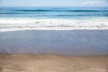 waves coming toward the sandy beach in the Pacific Northwest at Neskowin on a sunny summer day
