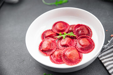 beetroot ravioli beet red pasta in the plate ready to eat appetizer meal food snack on the table copy space