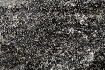 Stone texture abstract background. Close up natural dark mineral rock backdrop.