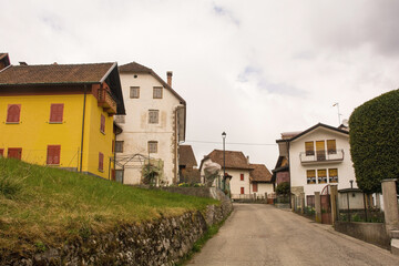 Fototapeta na wymiar Historic residential buildings in the mountain village of Ovasta in Carnia, Udine Province, Friuli-Venezia Giulia, north east Italy