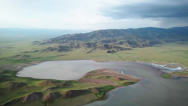 a beautiful lake among green hills. clouds over the lake
