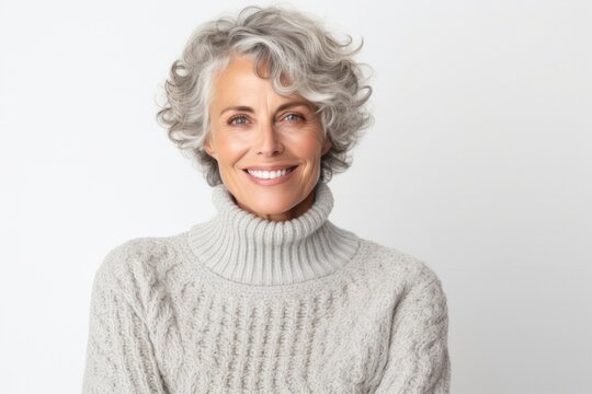 Cheerful senior woman with gray hair smiling in headshot portrait on white background