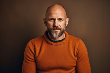 Fototapeta premium Confident mature man with a beard smiling in casual sweater